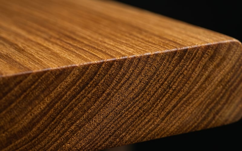 Close-up of ThermoWood timber grain showing the uniform honey-brown colour achieved through heat treatment at 215 degrees Celsius