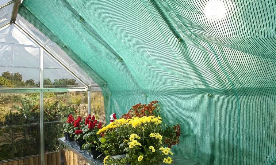 Palram Canopia Shade Kit fitted to a polycarbonate greenhouse roof to reduce summer heat and leaf scorch