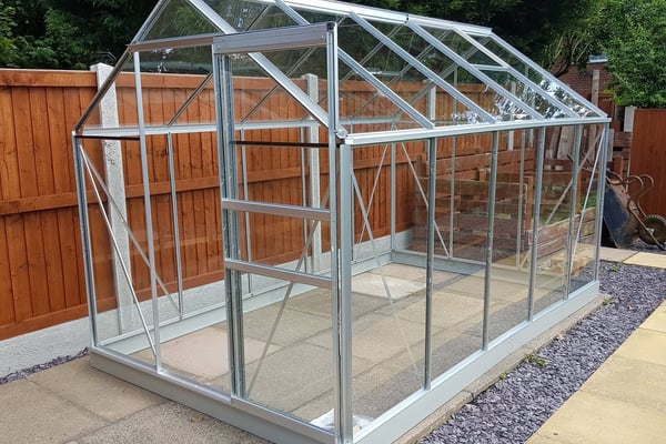 Vitavia Venus 6x10 silver aluminium greenhouse with toughened glass in a UK back garden